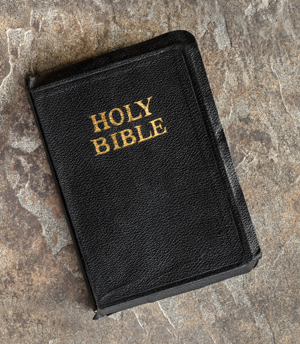 Old Bible Closed Top View over Stone Background Old Bible Closed Top View over Stone Background
